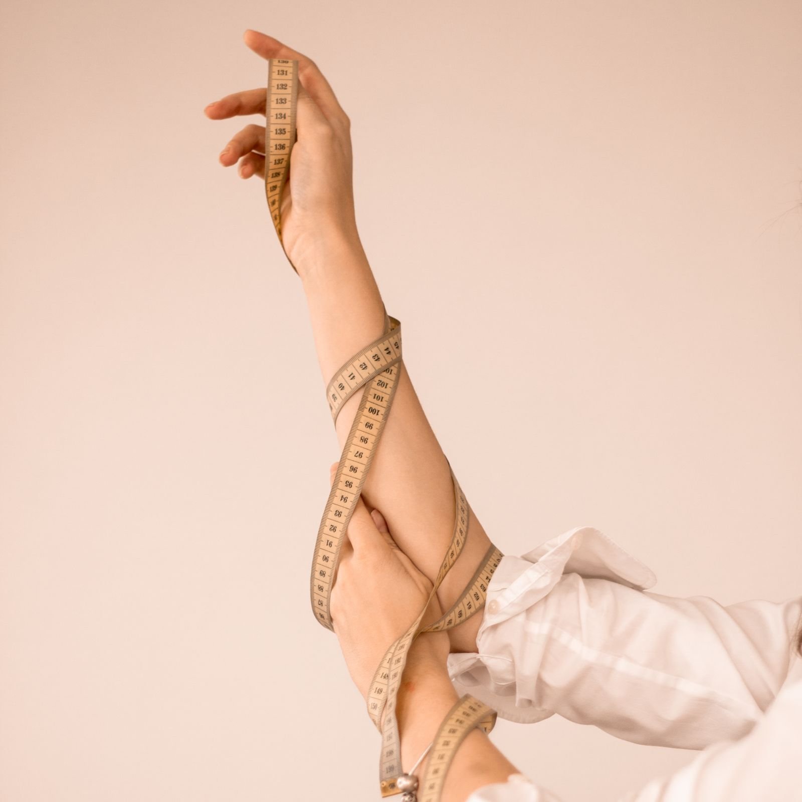 An arm being measured with a tape measure