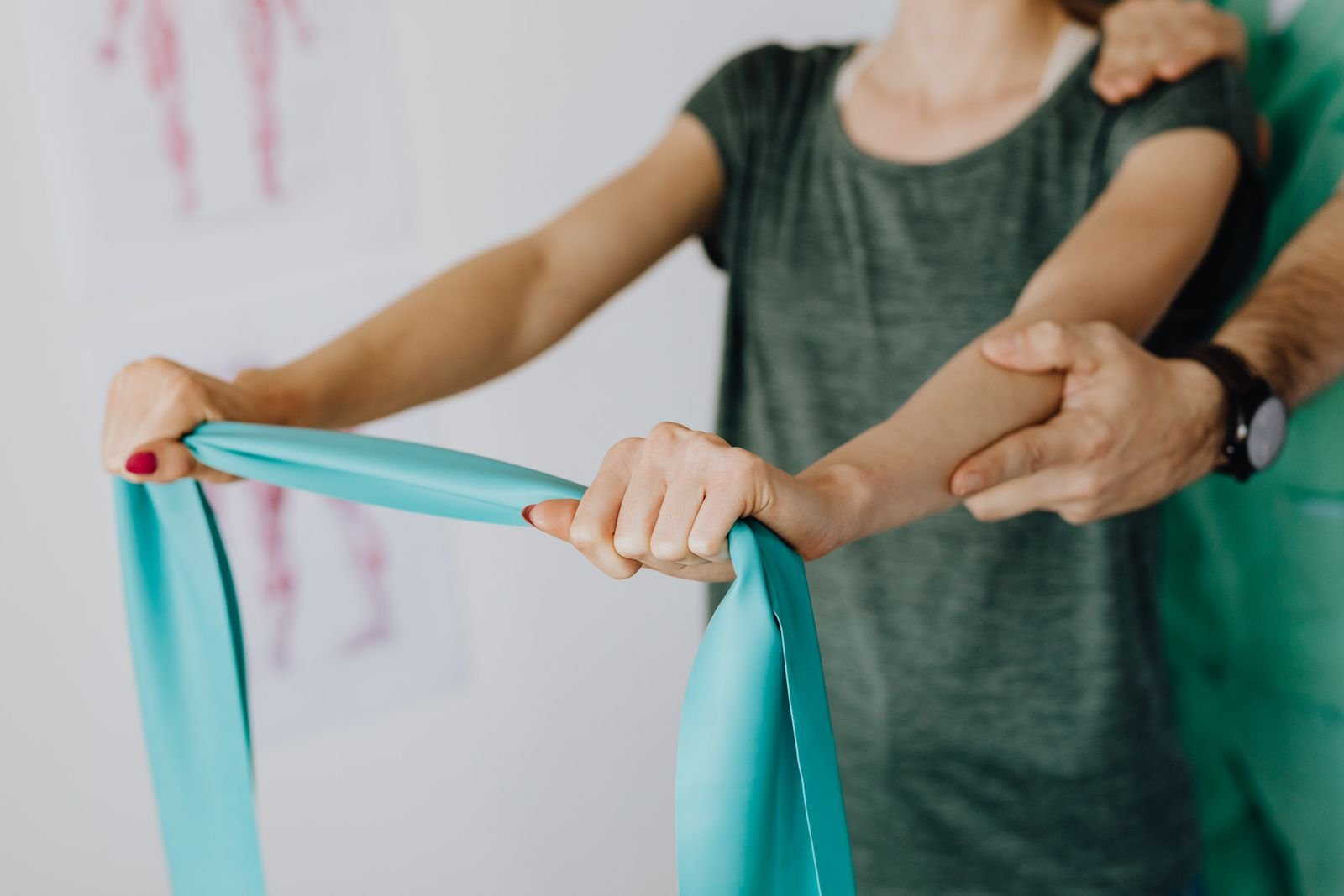 A therapist guiding a resistance band exercise